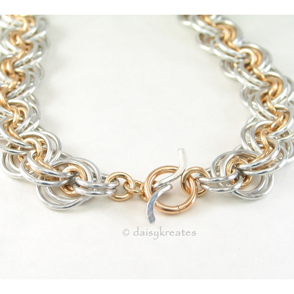 Necklace closes with gold tone toggle ring and silver tone Wave toggle bar