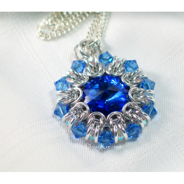 Clear and blue bicone beads form pointy outer rim as crystal ruffle