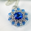 Clear and blue bicone beads form pointy outer rim as crystal ruffle