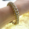 The bracelet measures 7 1/2" long, 1/2" wide, weighs less than 1 oz.